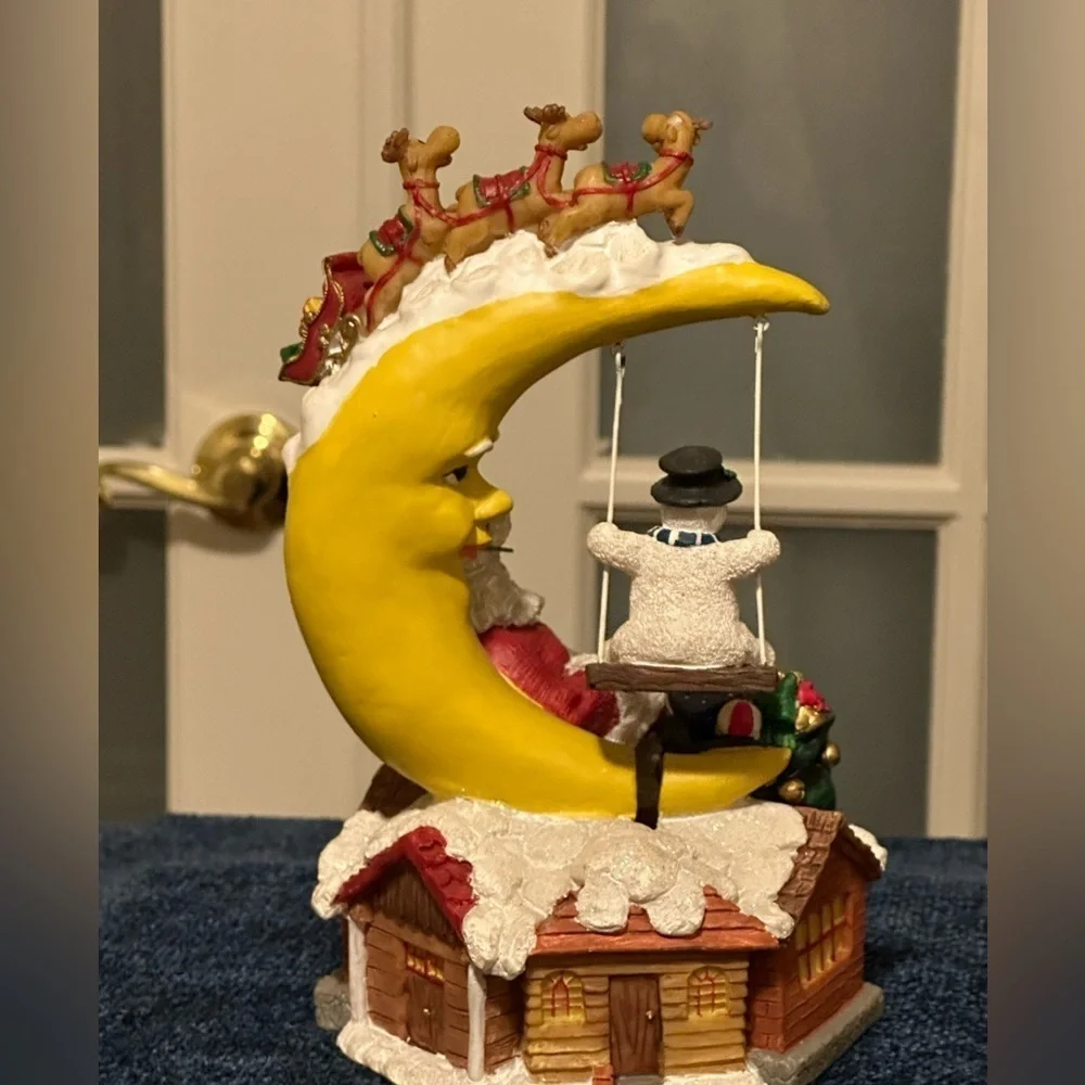 Sleepy Santa rests while a snow buddy swings. Missing bottom